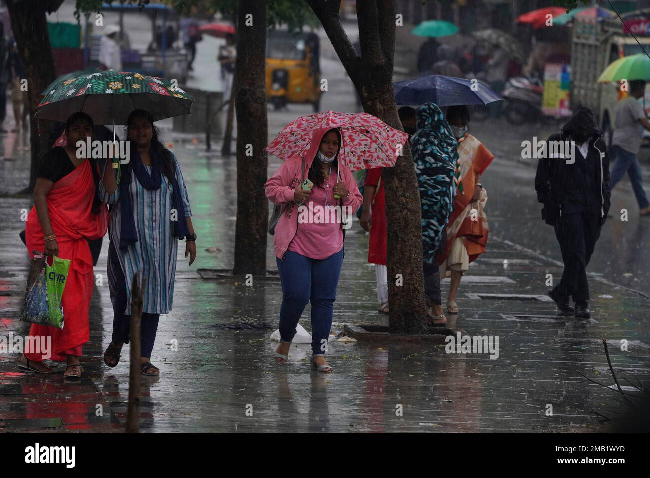 People walk with umbrellas in the rain in Hyderabad, India, Friday, July 22, 2022. The monsoon season in India lasts from June to September. (AP Photo/Mahesh Kumar A Stock Photo - Alamy